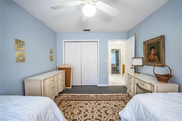 a bedroom with bed and cabinets