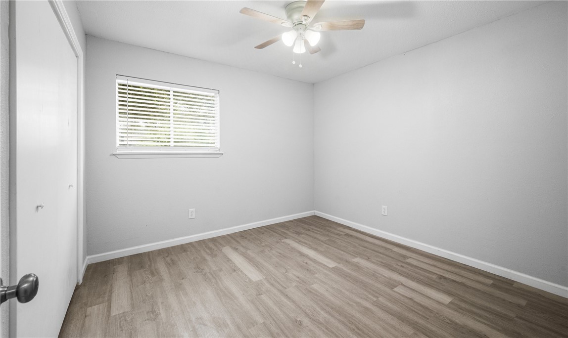 1021 Espana Drive Portland, TX 78374 - Photo 7 of 10 wooden floor in an empty room with a window