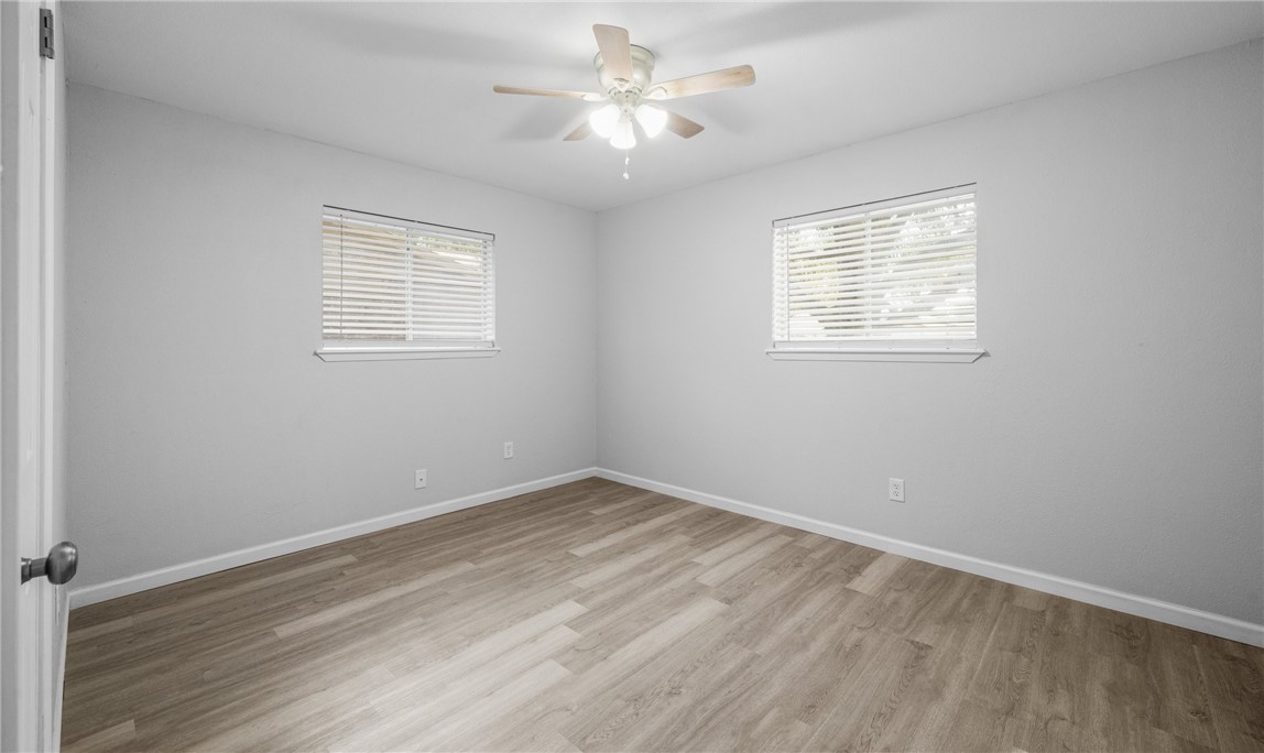 1021 Espana Drive Portland, TX 78374 - Photo 9 of 10 an empty room with a window and a ceiling fan