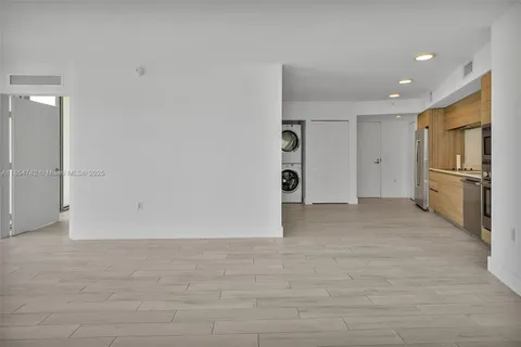 a view of a kitchen with a refrigerator and an oven