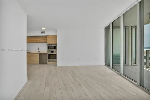 a view of a kitchen with wooden floor and a sink