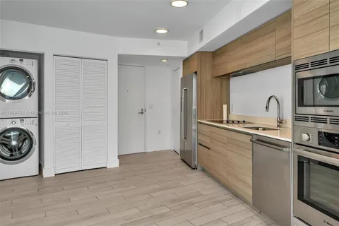 a kitchen with a sink and a stove top oven