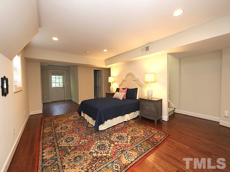 513 Spring Valley Drive Raleigh, NC 27609 - Photo 22 of 25 a bedroom with a bed and wooden floor