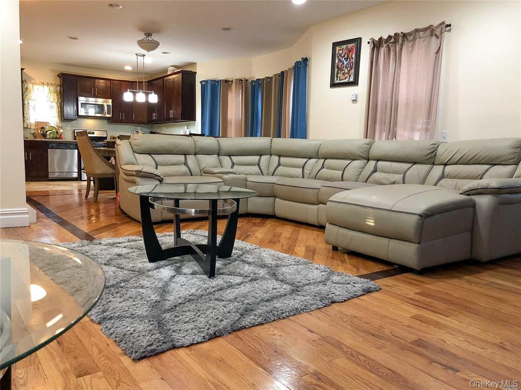 216-21 133rd Road Queens, NY 11413 - Photo 2 of 5 Living room with light wood finished floors and recessed lighting