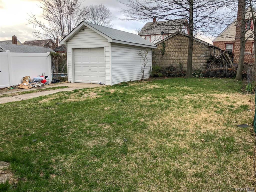 216-21 133rd Road Queens, NY 11413 - Photo 5 of 5 View of yard featuring an outbuilding and a garage