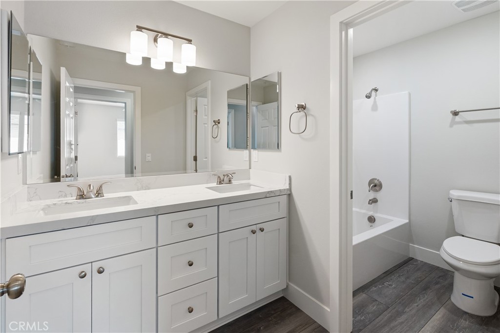6018 William Street Riverside, CA 92504 - Photo 25 of 59 a spacious bathroom with a double vanity sink a large mirror a shower and a bathtub