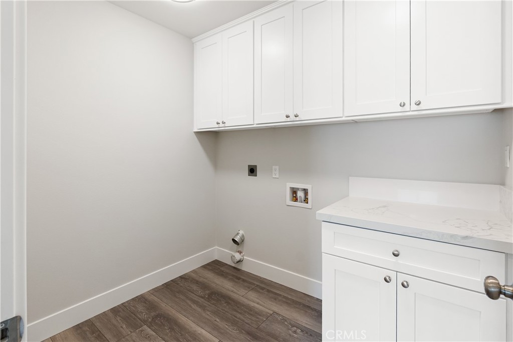 6018 William Street Riverside, CA 92504 - Photo 27 of 59 a view of cabinets and utility room with wooden floor