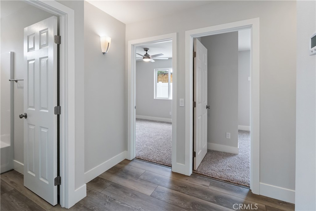 6018 William Street Riverside, CA 92504 - Photo 42 of 59 a view of a hallway with wooden floor and a bathroom