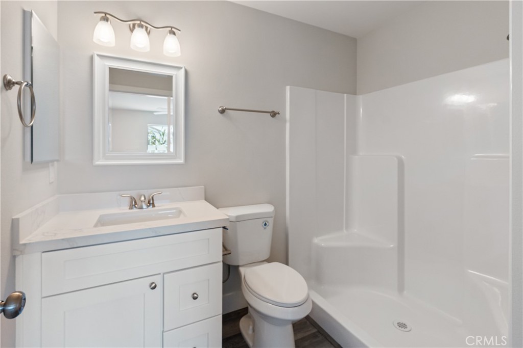 6018 William Street Riverside, CA 92504 - Photo 45 of 59 a bathroom with a toilet sink vanity and mirror