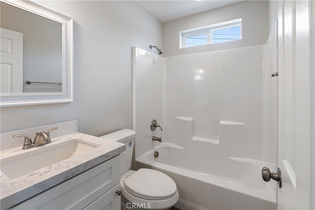 6018 William Street Riverside, CA 92504 - Photo 49 of 59 a bathroom with a granite countertop sink a toilet and shower