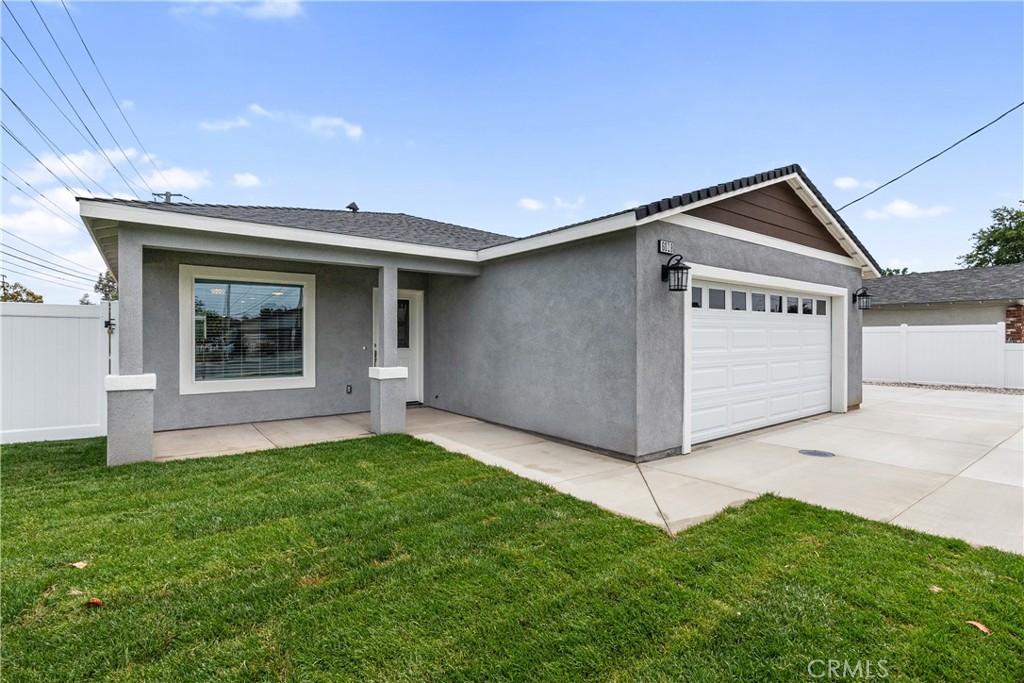 6018 William Street Riverside, CA 92504 - Photo 7 of 59 a front view of a house with a yard and garage