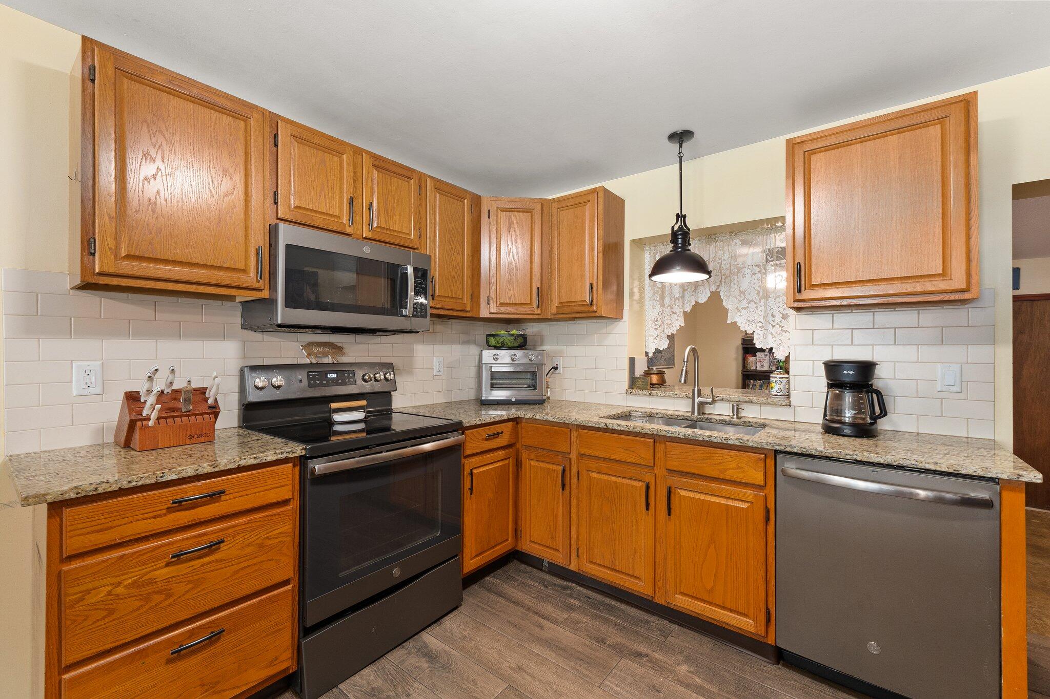 340 North Ffa Road Fort Pierce, FL 34945 - Photo 16 of 72 a kitchen with granite countertop a sink stainless steel appliances and cabinets