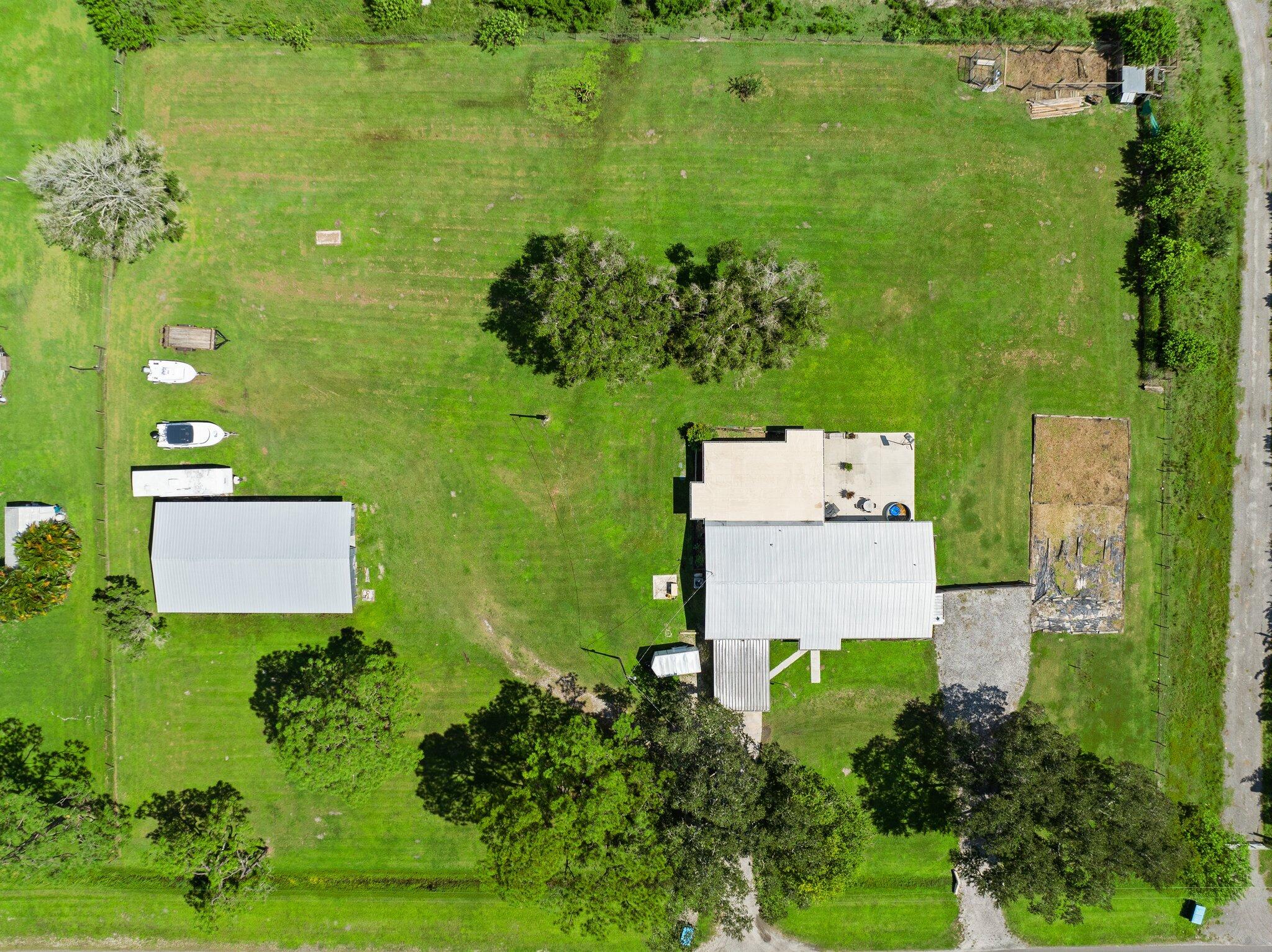 340 North Ffa Road Fort Pierce, FL 34945 - Photo 2 of 72 an aerial view of a house with a yard swimming pool and outdoor seating