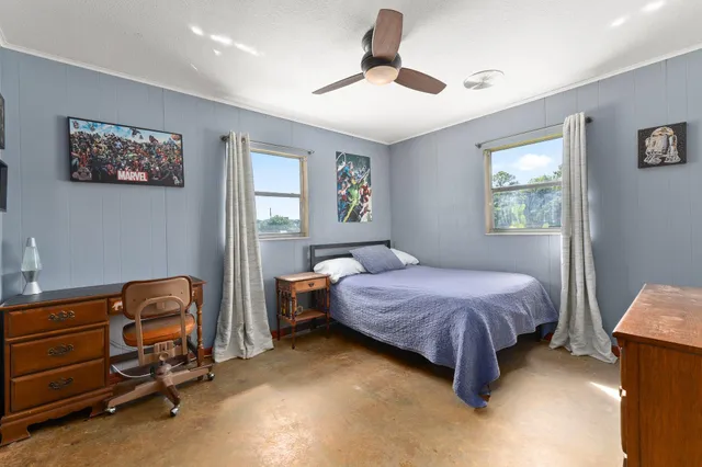 a bedroom with a bed and a tv