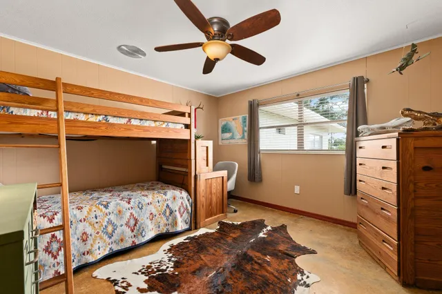 a spacious bathroom with a granite countertop sink a toilet a mirror and shower