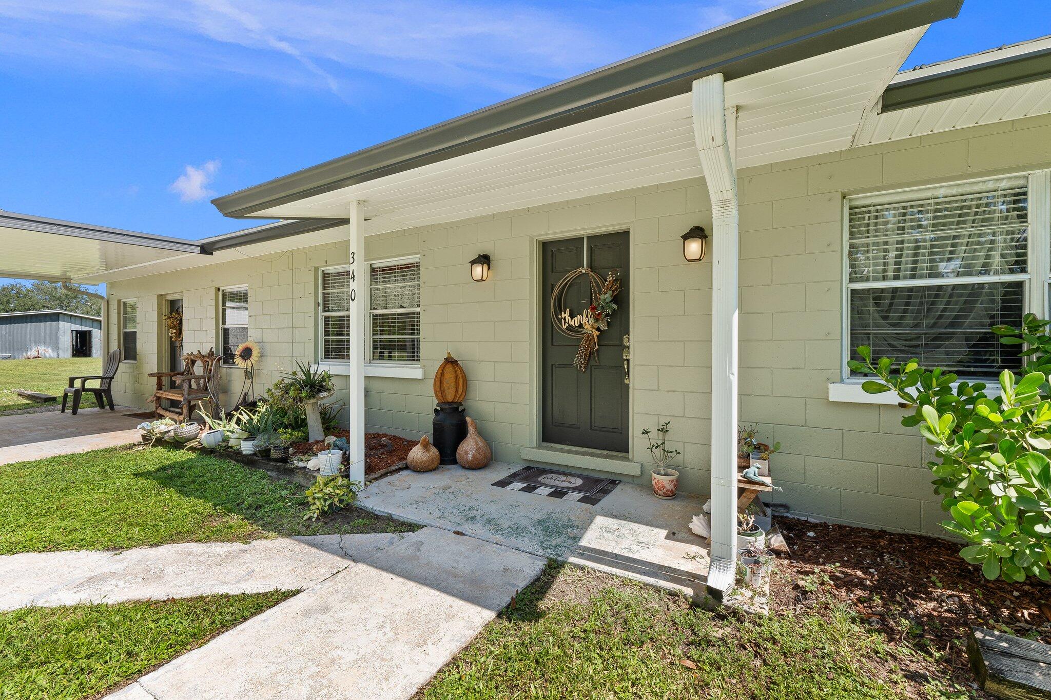 340 North Ffa Road Fort Pierce, FL 34945 - Photo 3 of 72 a front view of a house with a porch