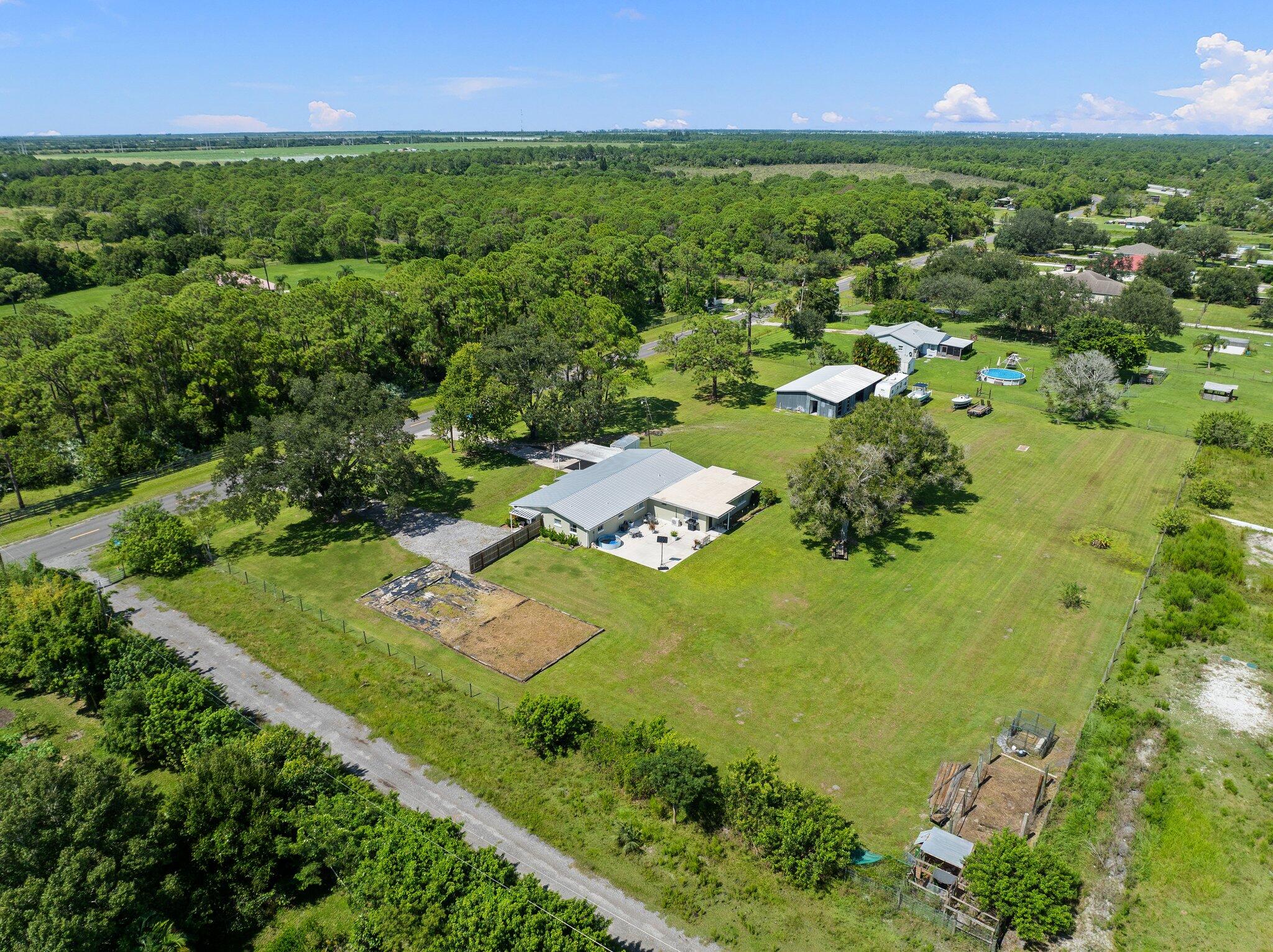 340 North Ffa Road Fort Pierce, FL 34945 - Photo 52 of 72 an aerial view of residential houses with outdoor space and trees