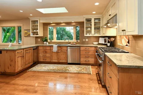 a kitchen with granite countertop a sink and a window