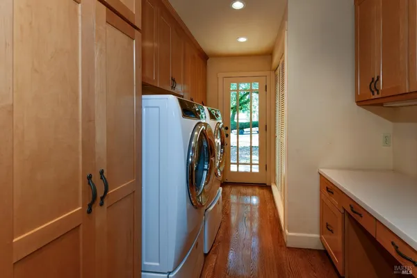 an aerial view of residential houses with outdoor space and trees