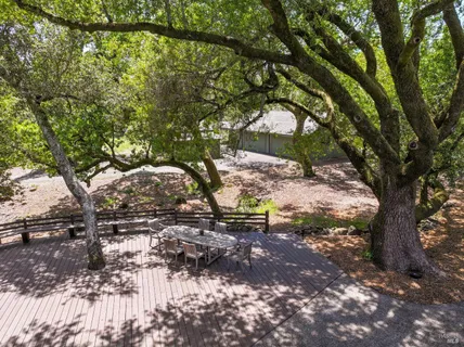 a view of a house with a small yard and wooden fence