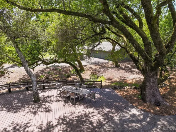 a view of a house with a small yard and wooden fence