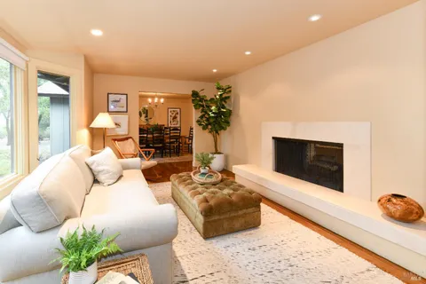 a living room with furniture a flat screen tv and a large window