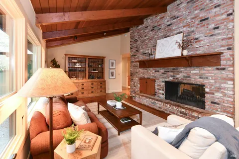 a living room with furniture rug and wooden floor