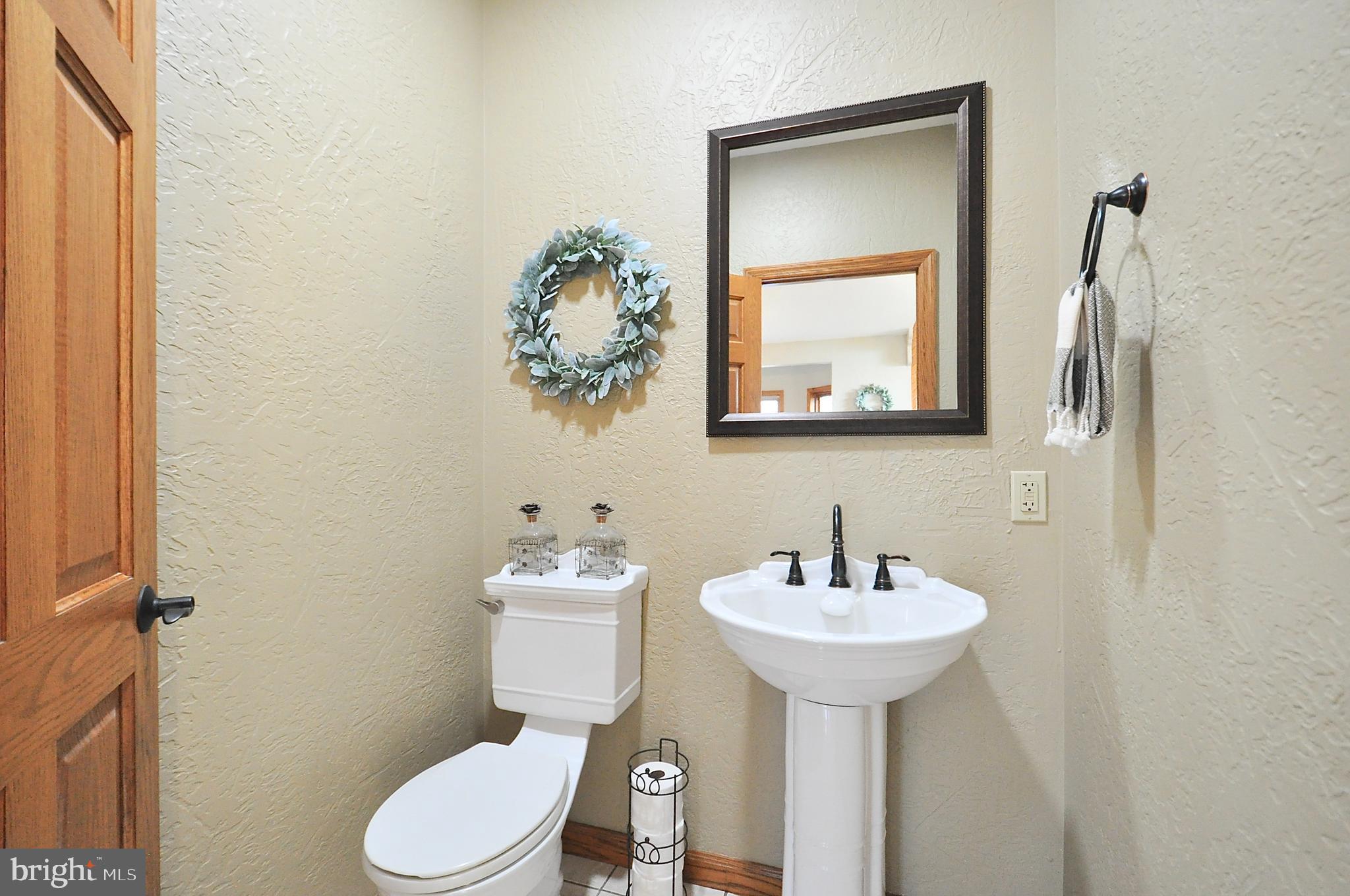 13370 South Eagle Valley Road Tyrone, PA 16686 - Photo 19 of 43 a bathroom with a toilet sink and mirror