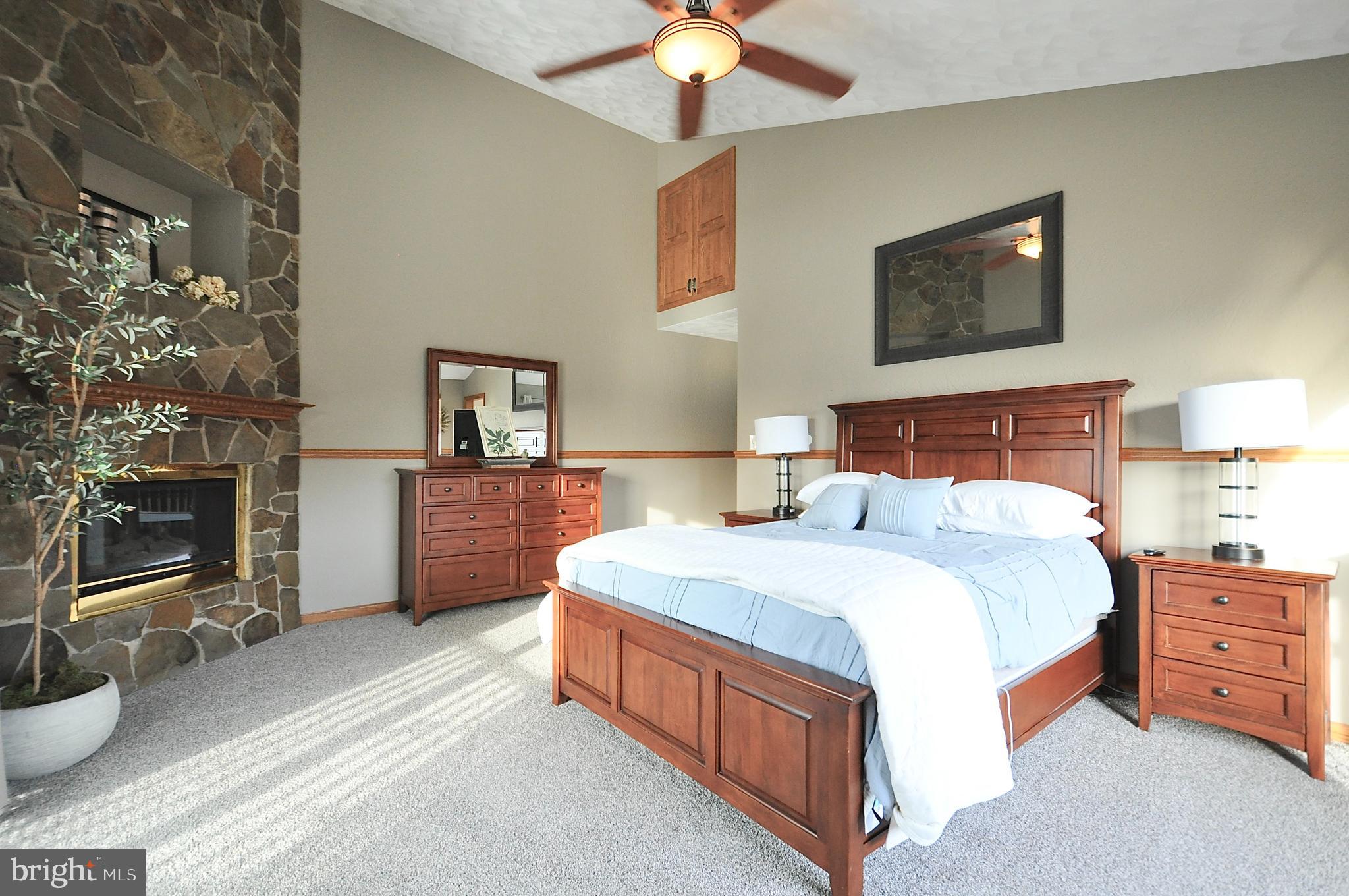 13370 South Eagle Valley Road Tyrone, PA 16686 - Photo 21 of 43 a spacious bedroom with a bed and a flat screen tv