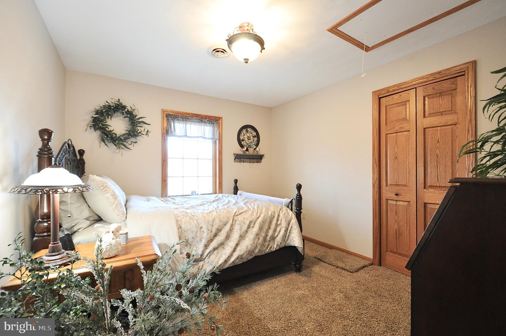 13370 South Eagle Valley Road Tyrone, PA 16686 - Photo 26 of 43 a bedroom with a bed and a chandelier