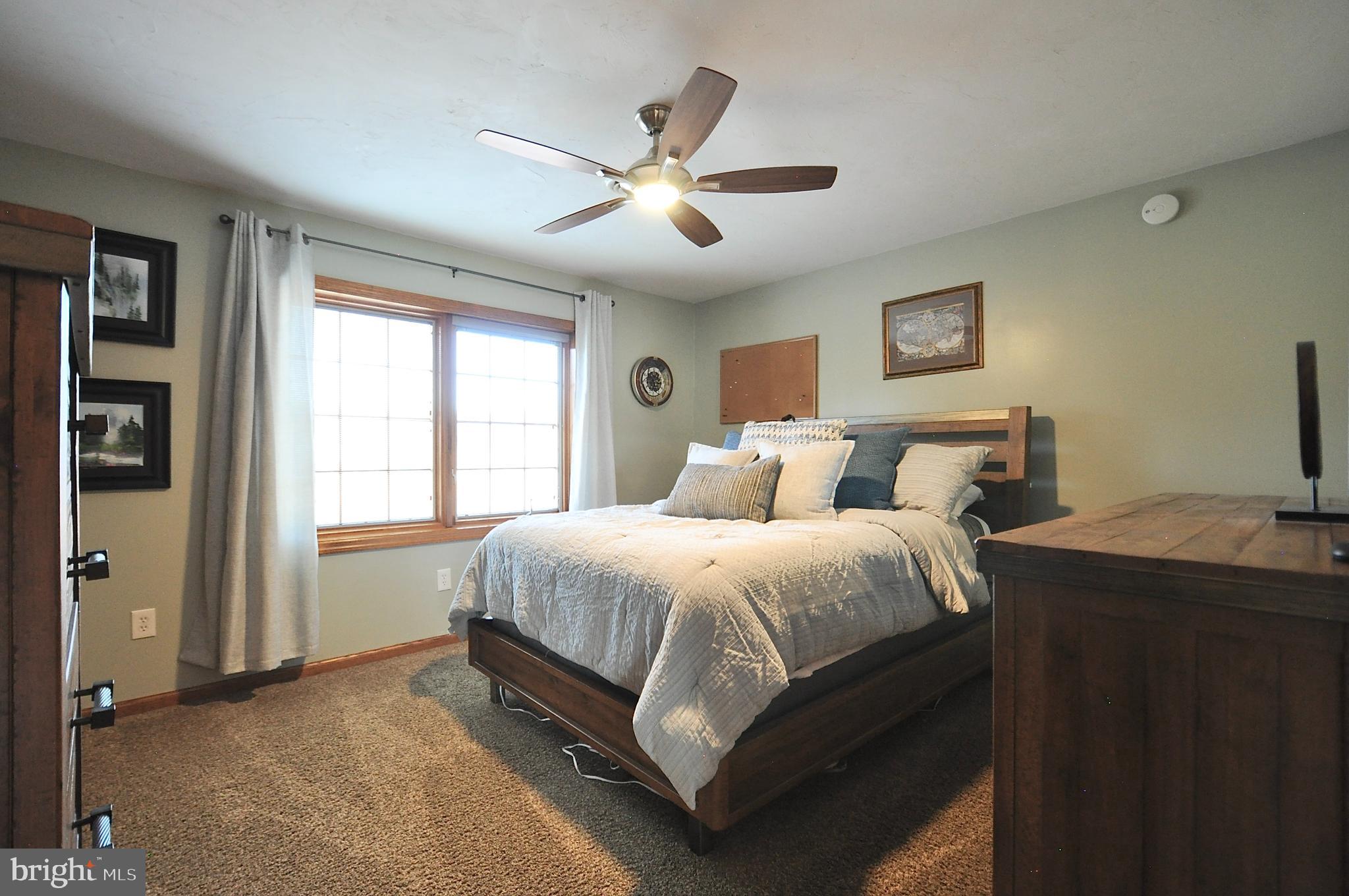 13370 South Eagle Valley Road Tyrone, PA 16686 - Photo 28 of 43 a spacious bedroom with a bed and a chandelier