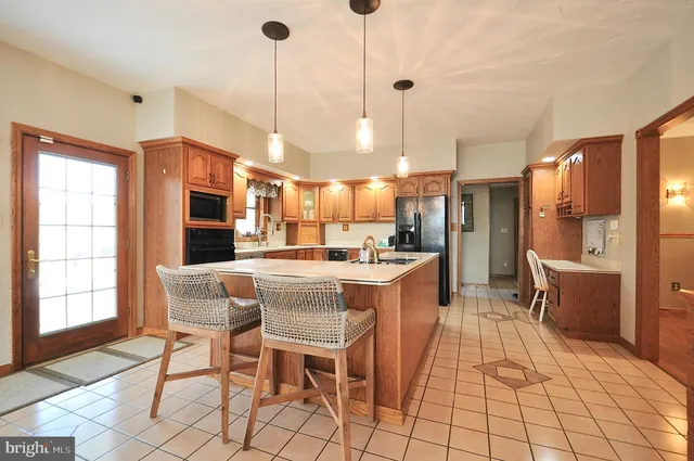 a very nice looking dining room with kitchen view and a chandelier
