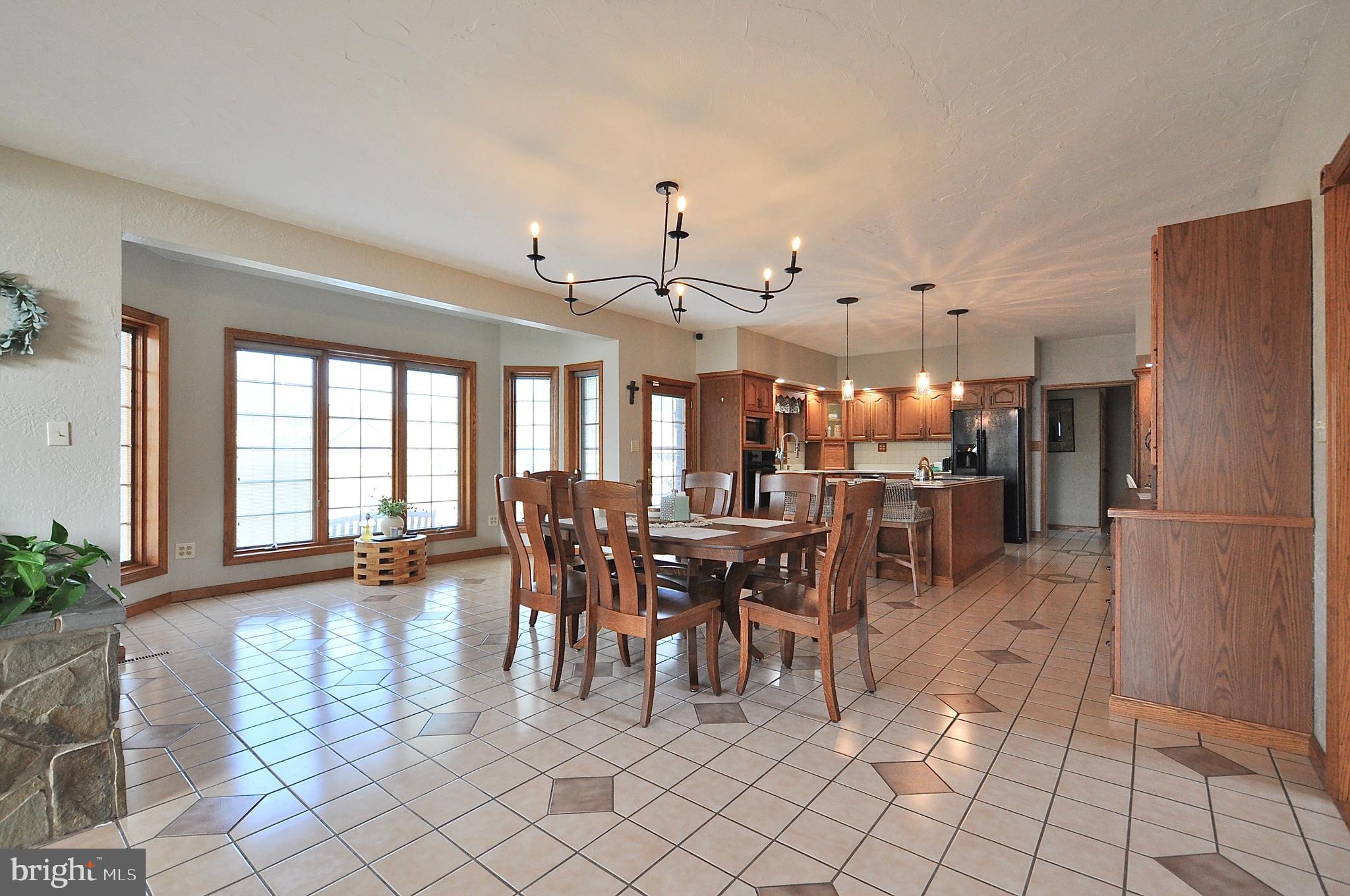 13370 South Eagle Valley Road Tyrone, PA 16686 - Photo 9 of 43 a very nice looking dining room with kitchen view and a chandelier