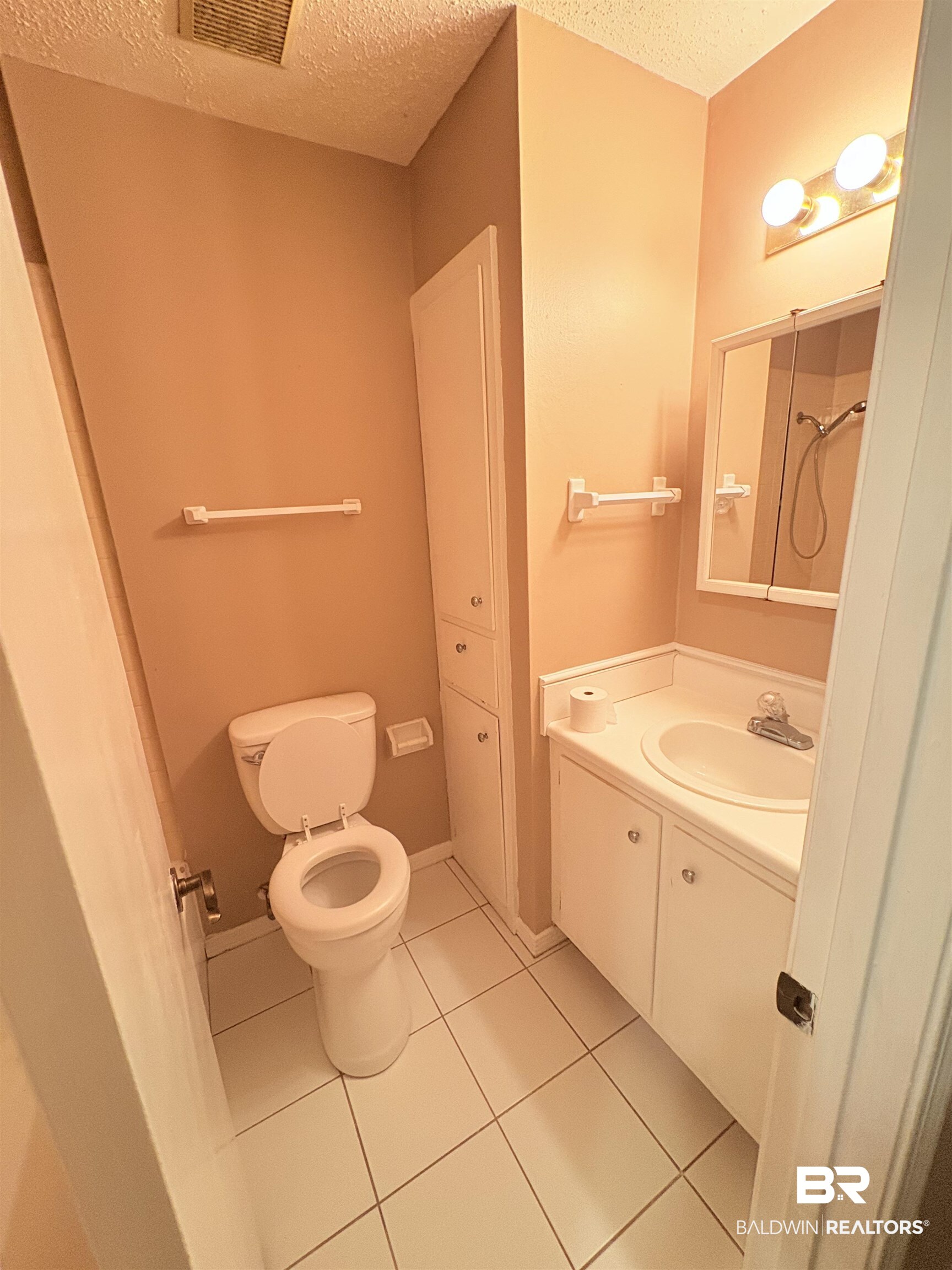 8070 Middle Ring Road Mobile, AL 36619 - Photo 21 of 26 Bathroom with a textured ceiling, vanity, and tile patterned floors