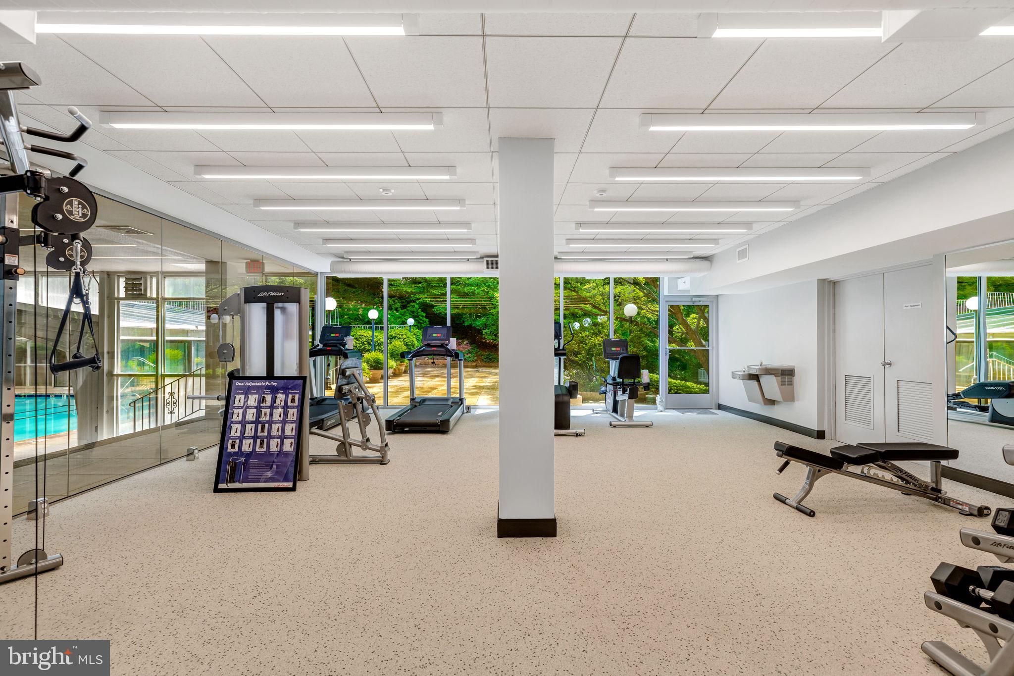 4100 Cathedral Avenue Northwest, Unit 712 Washington, DC 20016 - Photo 19 of 24 a room with gym equipment and large windows