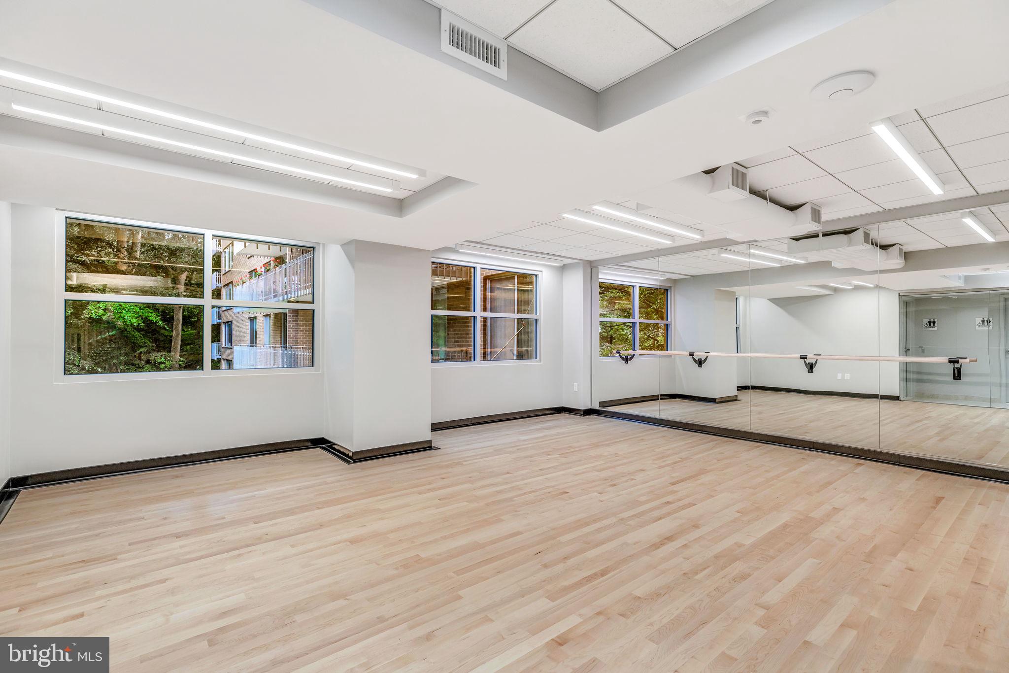 4100 Cathedral Avenue Northwest, Unit 712 Washington, DC 20016 - Photo 22 of 24 a view of an empty room with a window and wooden floor