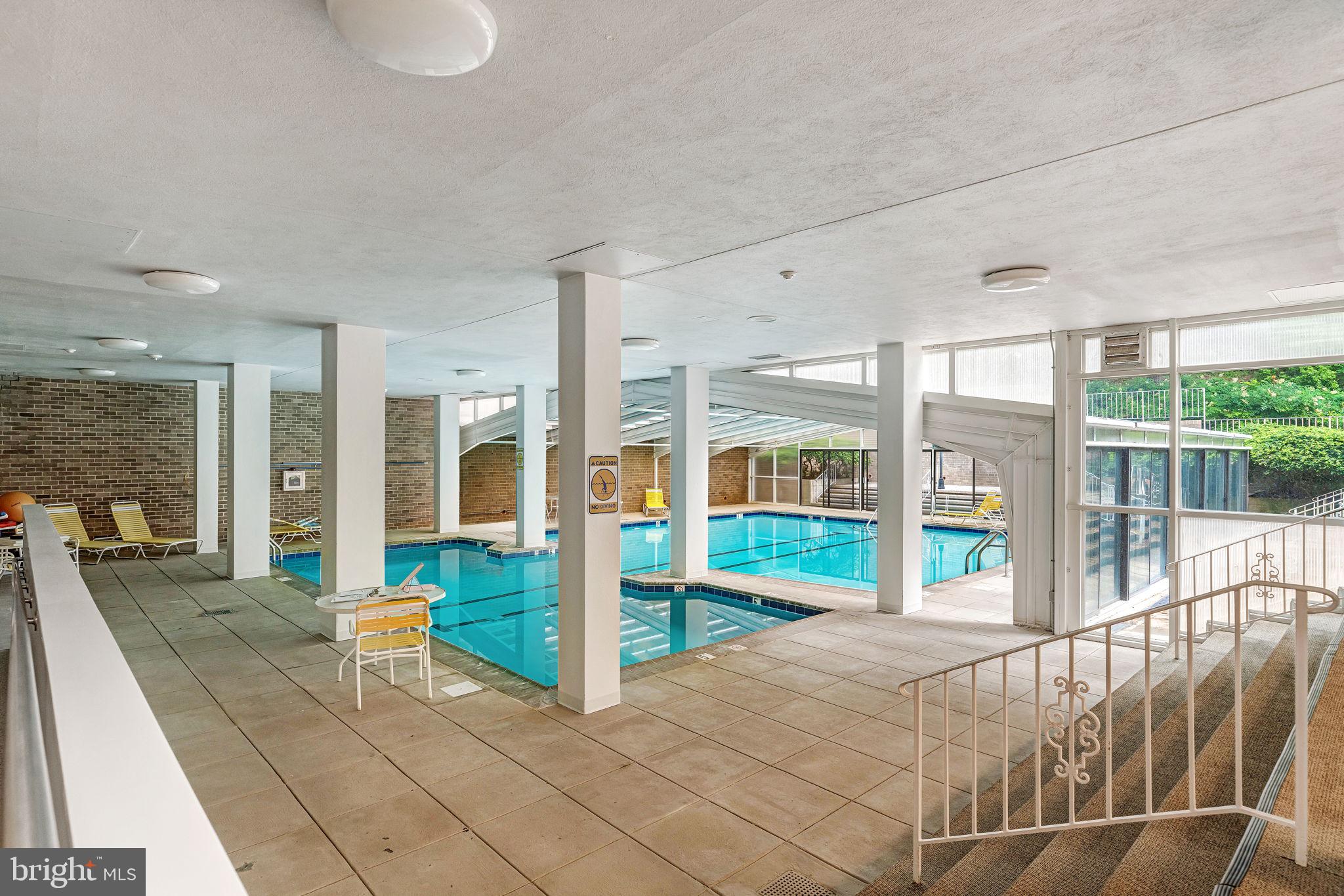 4100 Cathedral Avenue Northwest, Unit 712 Washington, DC 20016 - Photo 24 of 24 a living room with furniture and floor to ceiling windows