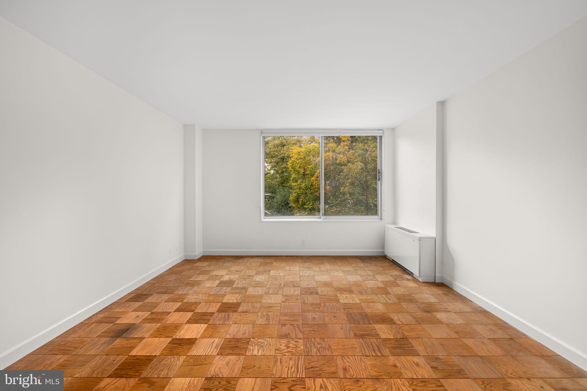 4100 Cathedral Avenue Northwest, Unit 712 Washington, DC 20016 - Photo 9 of 24 an empty room with windows