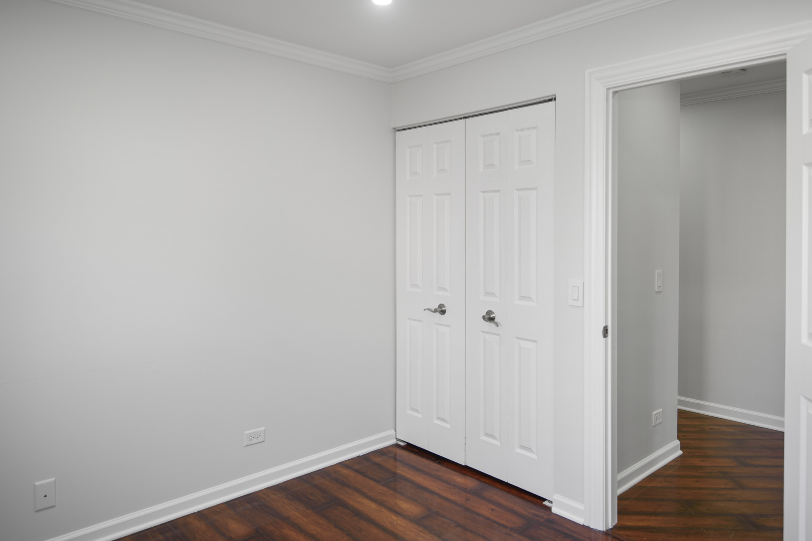 1168 Middlebury Lane, Unit A1 Wheeling, IL 60090 - Photo 19 of 28 a view of an empty room with wooden floor