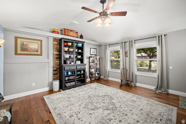 236 West 300 South Hurricane, UT 84737 - Photo 8 of 76 Spacious room featuring rich wood-finish flooring, light gray wall tones, and an exposed brick accent wall