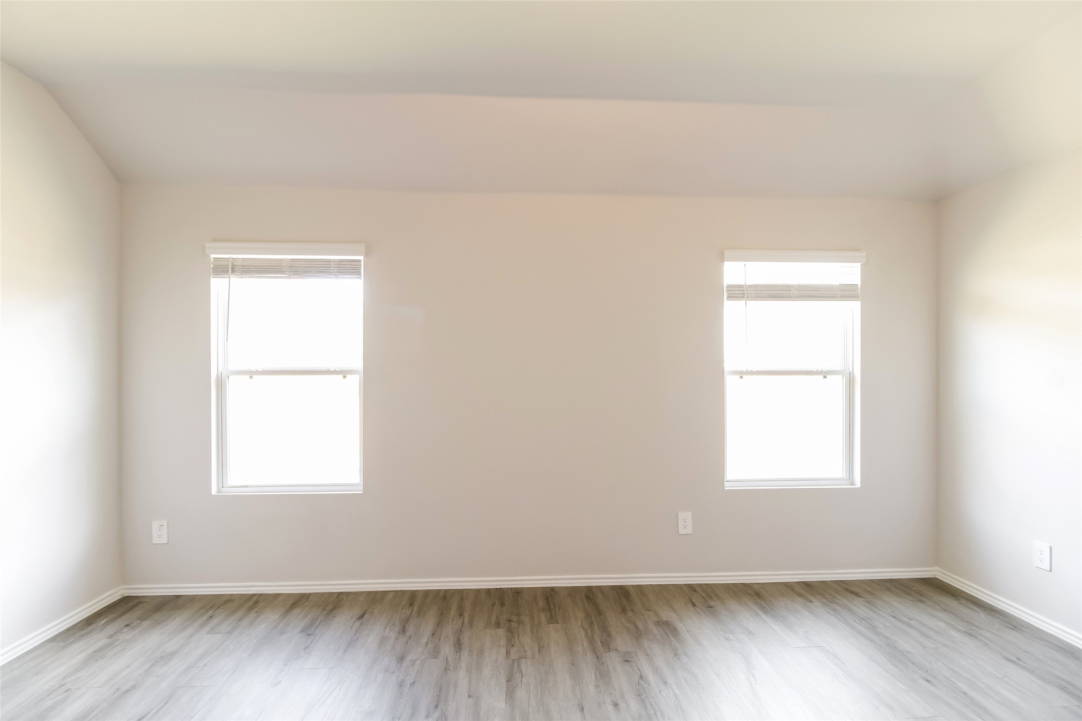 2528 Shad Drive Conroe, TX 77384 - Photo 6 of 16 an empty room with wooden floor and windows
