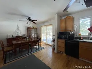 a living room with furniture a flat screen tv and kitchen view