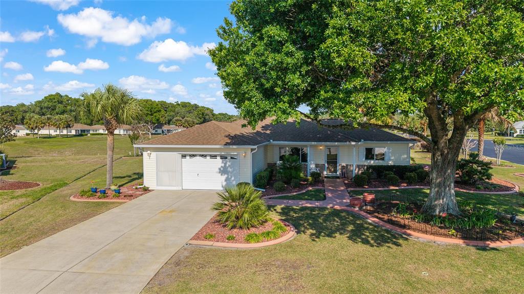 11273 Southwest 136th Place Dunnellon, FL 34432 - Photo 1 of 78 a front view of house with yard outdoor seating and green space