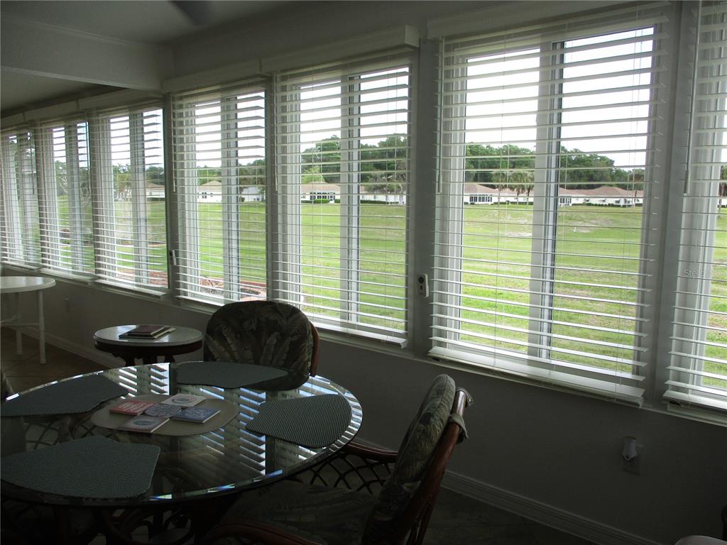 11273 Southwest 136th Place Dunnellon, FL 34432 - Photo 21 of 78 a living room with furniture and floor to ceiling windows