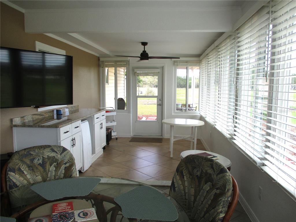11273 Southwest 136th Place Dunnellon, FL 34432 - Photo 22 of 78 a living room with furniture and a flat screen tv