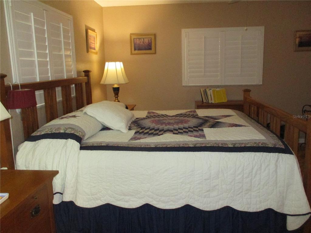 11273 Southwest 136th Place Dunnellon, FL 34432 - Photo 24 of 78 a bedroom with a bed and wooden floor
