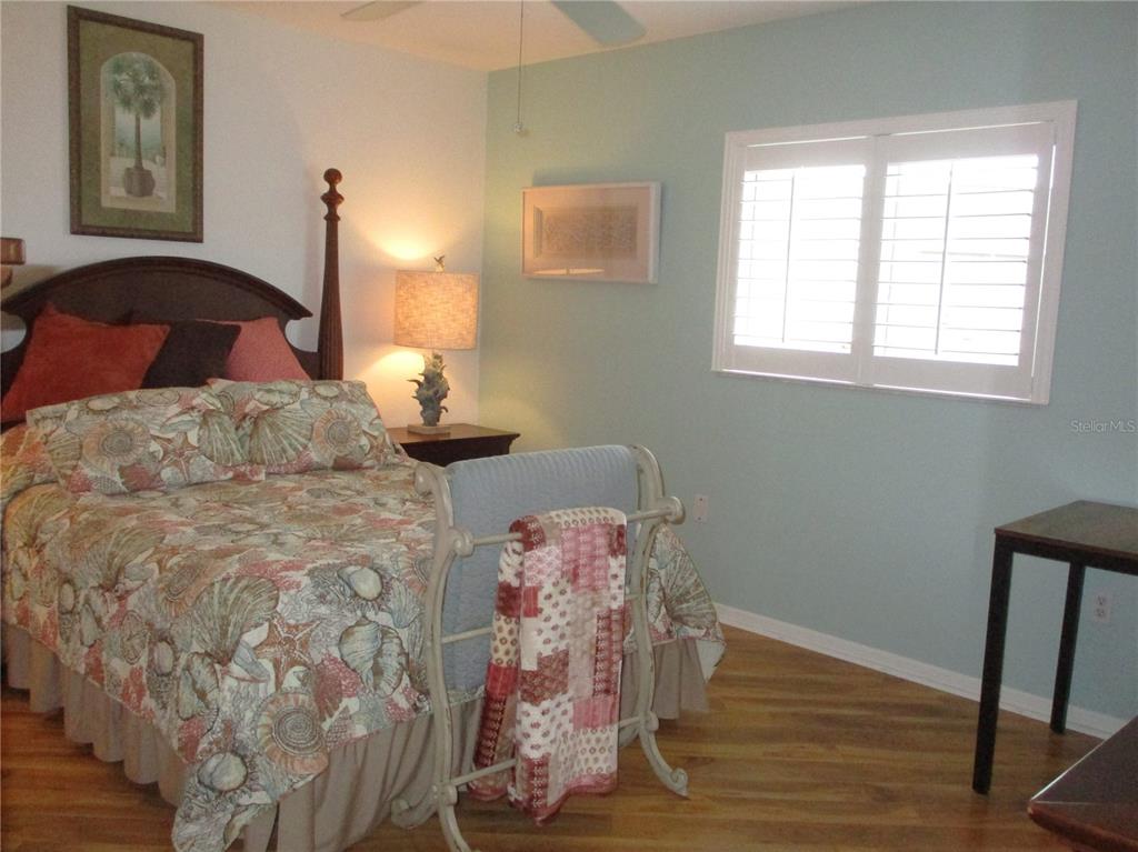 11273 Southwest 136th Place Dunnellon, FL 34432 - Photo 32 of 78 a bedroom with a bed and wooden floor