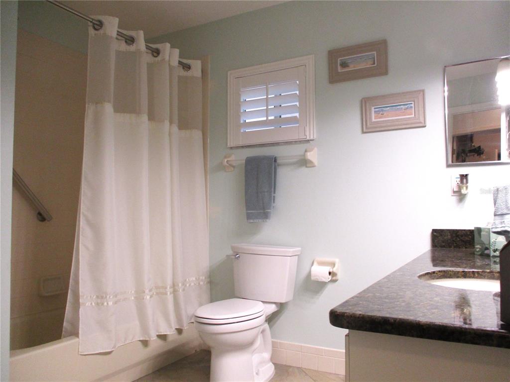 11273 Southwest 136th Place Dunnellon, FL 34432 - Photo 36 of 78 a bathroom with a granite countertop sink a toilet and a shower