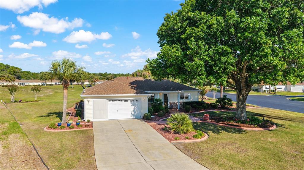 11273 Southwest 136th Place Dunnellon, FL 34432 - Photo 48 of 78 a front view of a house with swimming pool and outdoor seating
