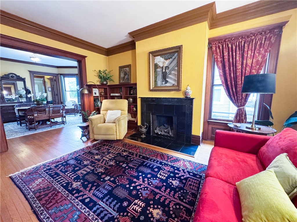 106 Argyle Street Rochester, NY 14607 - Photo 5 of 50 The 1st floor unit front parlor invites you in with it’s grandeur and original wood trim.